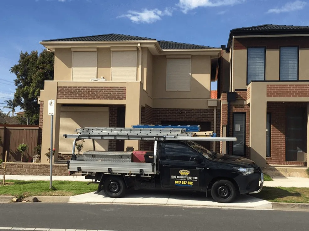 Home with cream roller shutters installed on all windows by professional roller shutter service.