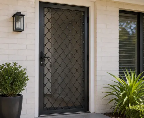 Security door screen repair and replacement by a technician repairing damaged security screen mesh on a residential door