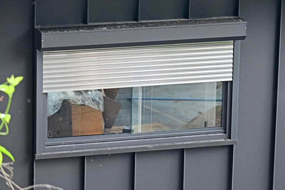 Electric roller shutter stuck halfway on a residential window